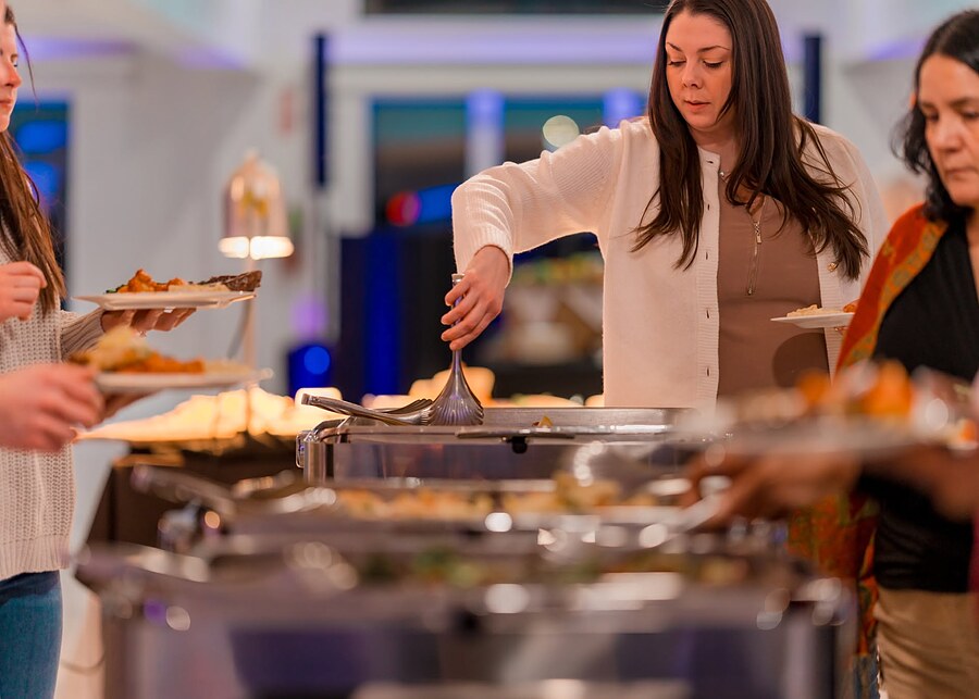 Guests serving themselves at a catered buffet during a company event