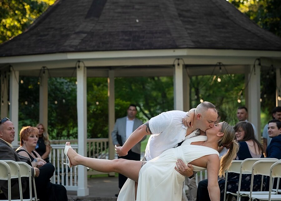 Bride and groom kiss at the gazebo after their Rochester, NY wedding ceremony