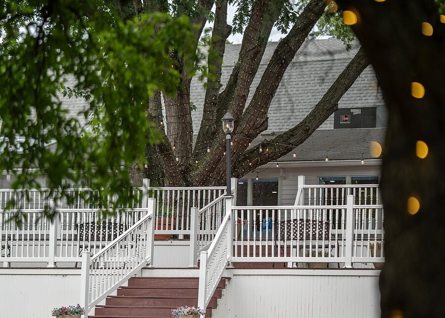 The multi-level deck under a string-lit tree