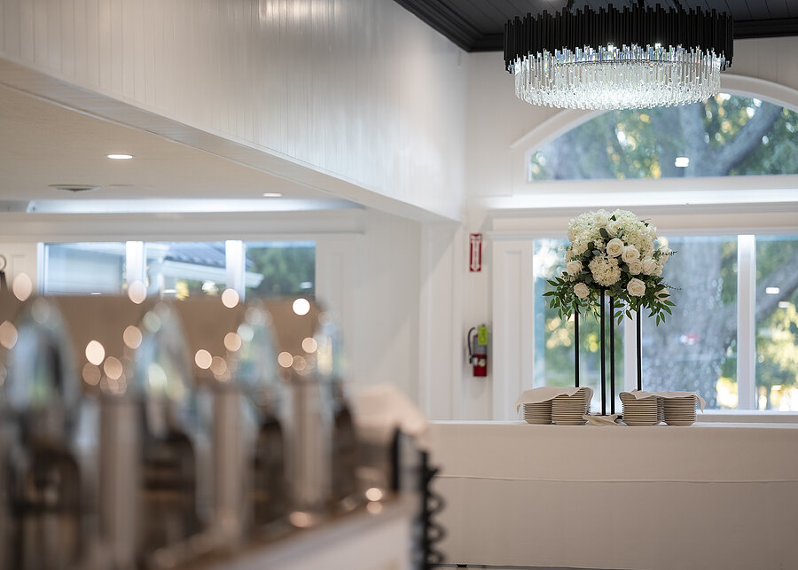 The remodeled banquet hall with chandeliers and arched windows at Chef's Event Center near Rochester, NY