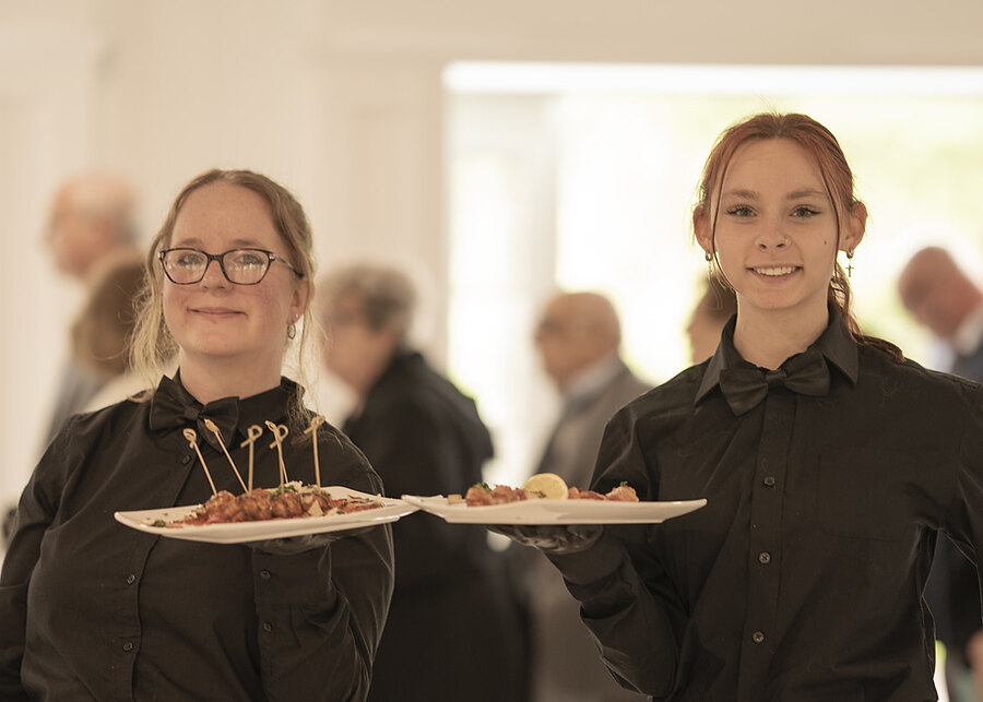 Chef's Catering staff serving appetizers to guests