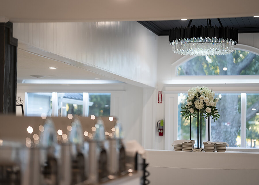 The renovated banquet hall with chandeliers and arched windows