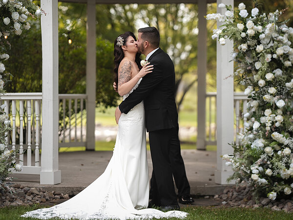 A couple at the gazebo under a floral arch, Chef's Event Center near Rochester, NY