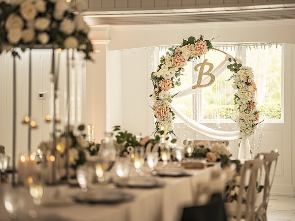 Head table with florals and candles in the banquet hall, Chef's Event Center near Rochester, NY