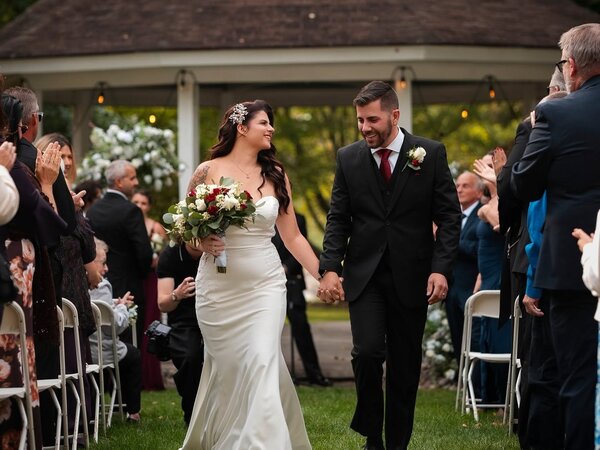 A couple walks back up the aisle at the gazebo, Chef's Event Center near Rochester, NY
