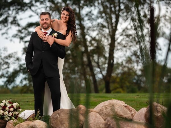A couple poses at the stone waterfall, Chef's Event Center near Rochester, NY